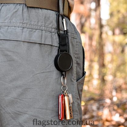 Order a retractable keychain with a carabiner for attaching to a belt/strap.
